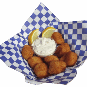Basket of fried hush puppies with dipping sauce and lemon wedges.