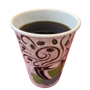 A cup of black coffee in a decorative paper cup.