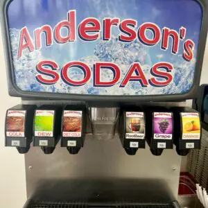 Soda fountain with six flavored options at Anderson's Sodas.